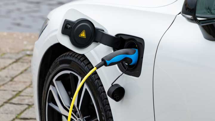 White Porsche charging, close up of cable plugged into port